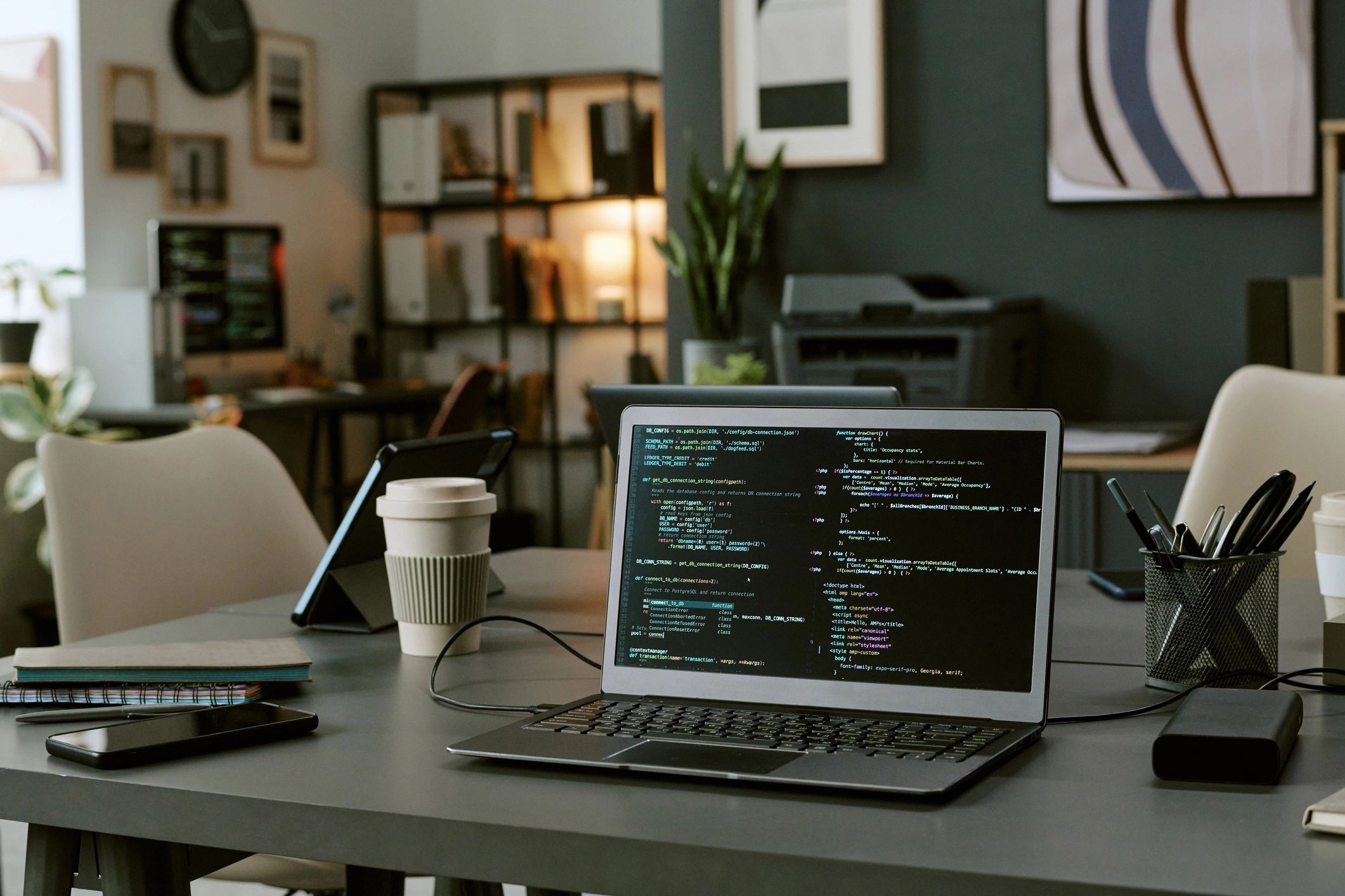 Laptop displaying programming code on screen on a desk